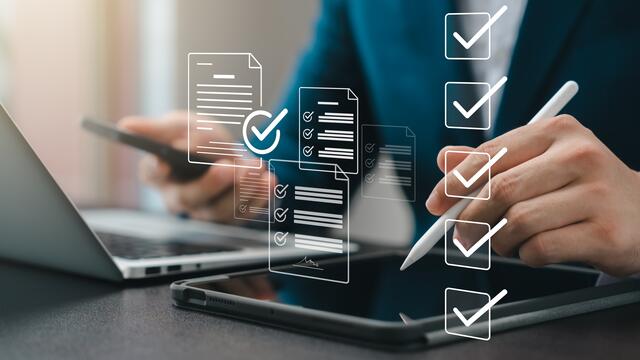 Person using electronic devices to complete a form