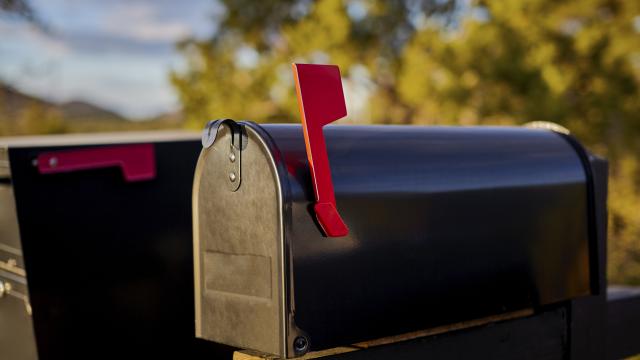 Black mailbox with red flag up