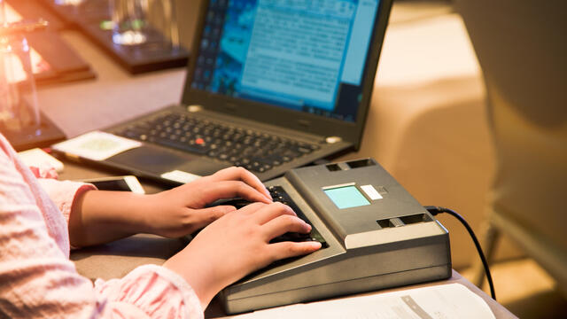 Stenographer using a shorthand stenography machine