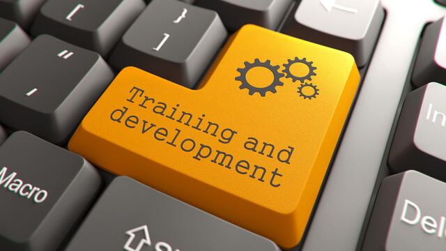 Three gears and "training and development" on the orange enter key.