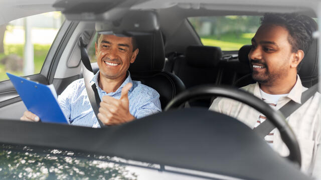 Adult teaches another adult to drive
