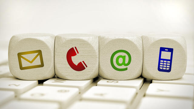 Four wood blocks with contact us icons on each.