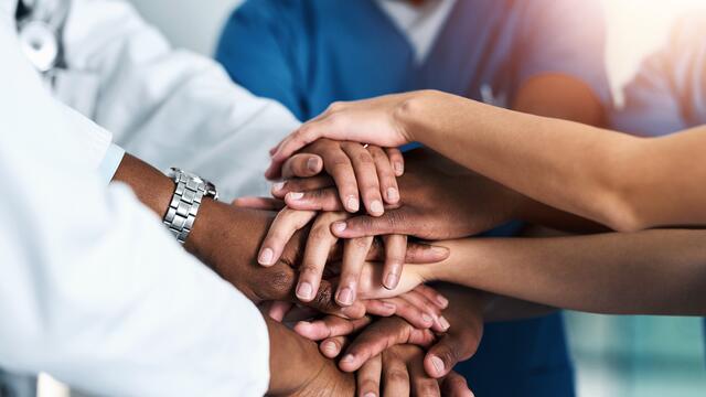 Hand stack with four medical staff