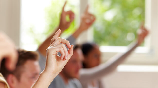 Hands raised in a room