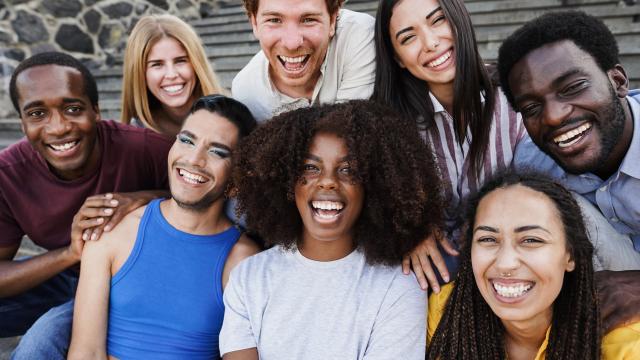 A group of eight young adults laughing