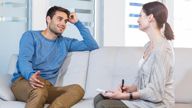 Patient on sofa talking to a psychologist