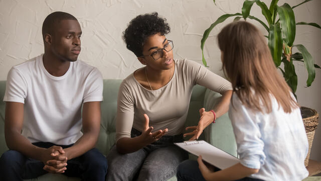 Two adults talking to a counselor