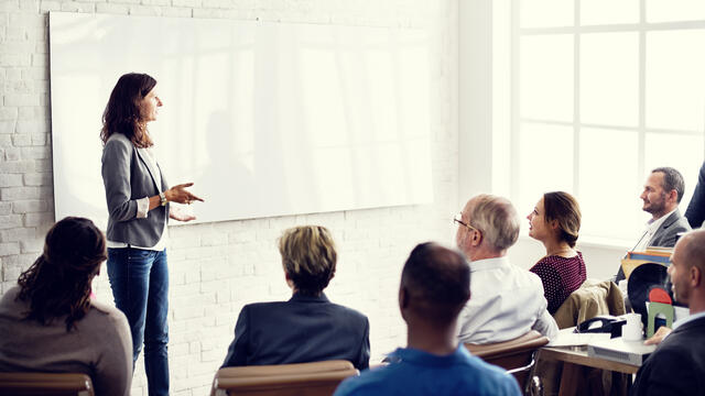 A presenter speaking to an audience.