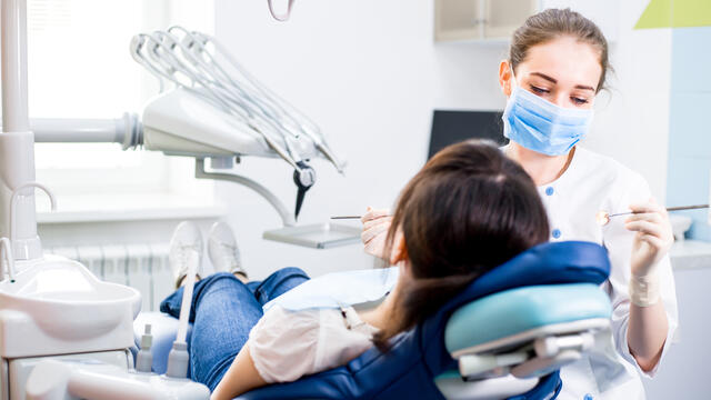 Dentist examining a person's teeth