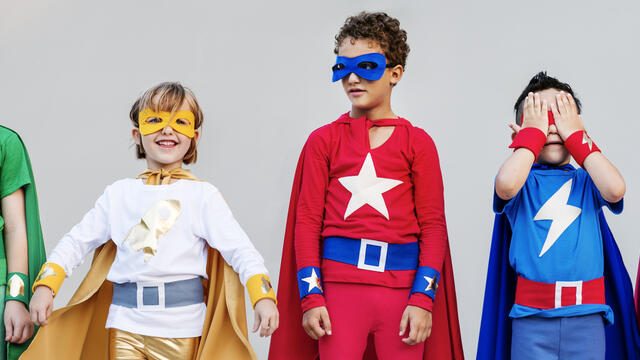 Five children dressed as super heros