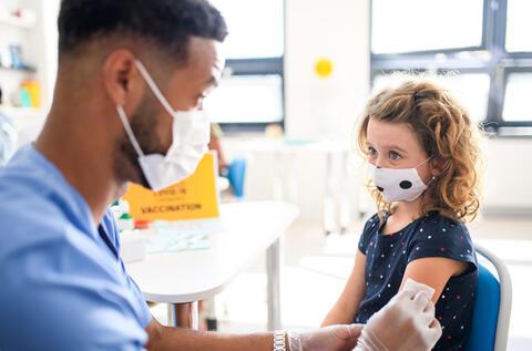 Doctor giving a child a vaccination