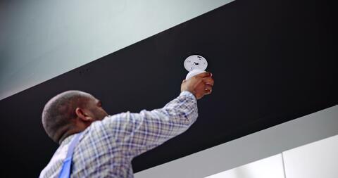 Adult installs a smoke detector