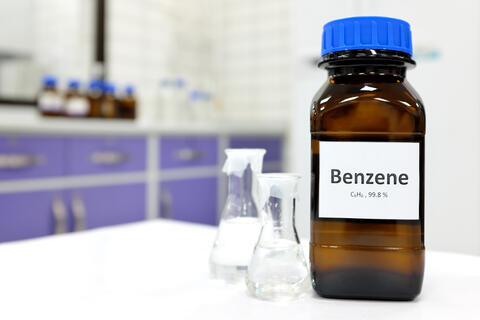 Brown bottle of benzene on a lab table