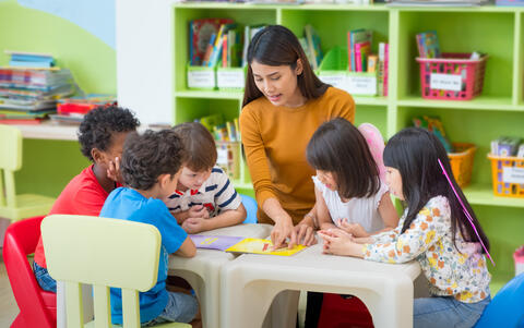 Adult teaching young children