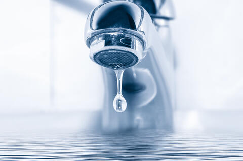 A drip of water from a faucet.
