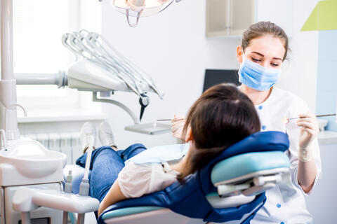 Dentist examining a person's teeth