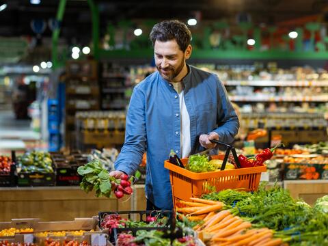 Adult selects vegetables in a market