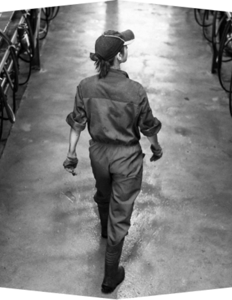 Farm worker walking wearing protective gear