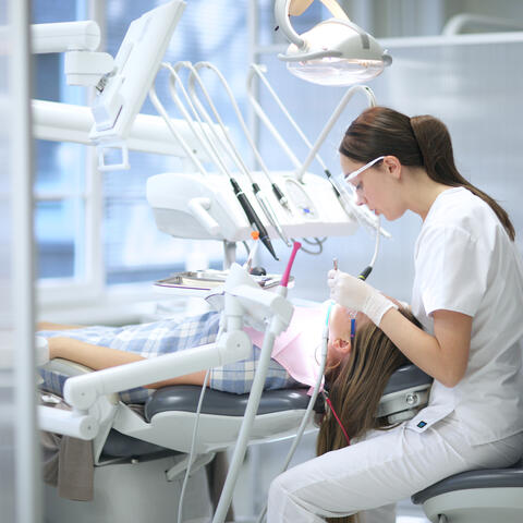 Student performing dental care on a patient