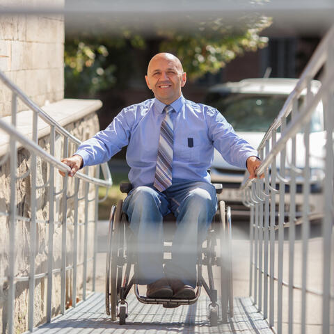 Person going up a ramp in a wheelchair