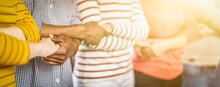Close up of adults arms crossed and hands together