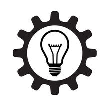 A light bulb inside a gear wheel.