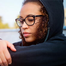 Close up of teen sitting by water