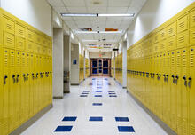 A school hallway with yellow lockers.