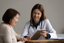 Doctor discusses care plan with older adult