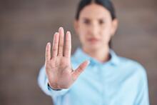 Blurred adult with hand out in a stop sign.