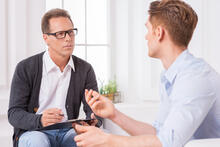 Two adults consult together