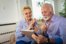 Couple using sign language to communicate on a tablet
