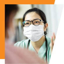 Close up of a nurse with glasses wearing a mask