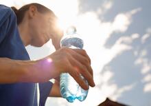 Person drinking water in the heat