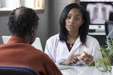 A doctor explaining medication to her patient