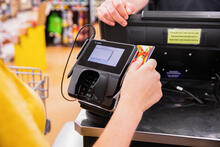 Person using a card reader to pay