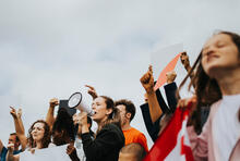 A group of activists, one with a megaphone