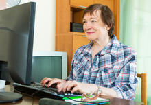 An adult using a computer at home.