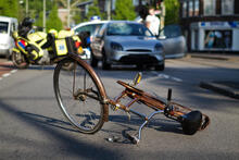 Police vehicles at scene of a bike accident