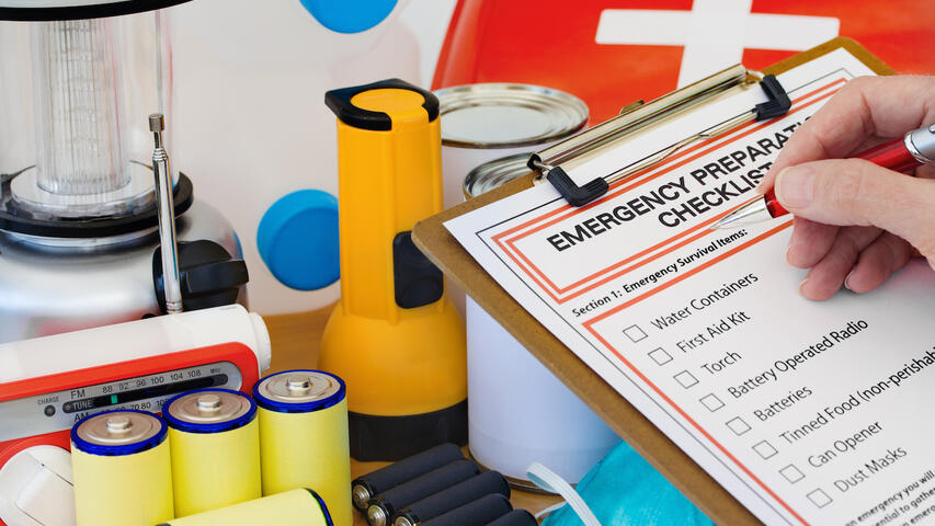 Emergency supplies shown with a checklist on clipboard