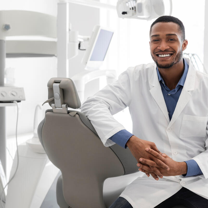 Smiling dentist in their office